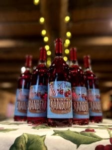 5 bottles of Cranberry wine on a table