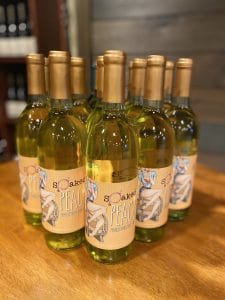 a group of Peach wine bottles sitting on a table